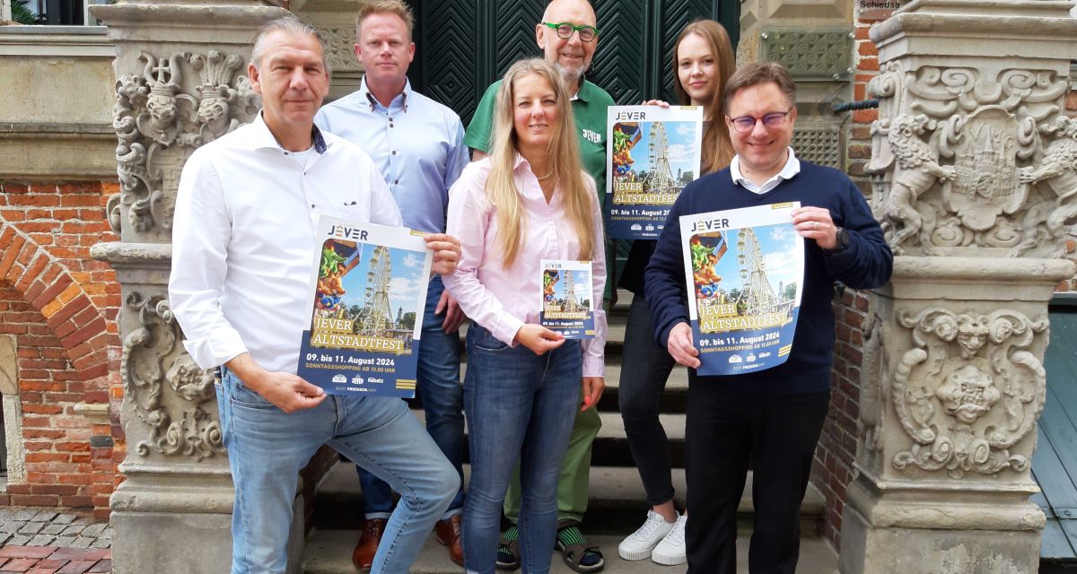 Veranstalter*innen des Altstadtfests Jever bei der Vorstellung des Programms für das Jahr 2024. Auf der Treppe des Jeverschen Rathauses mit entsprechenden Plakaten und Programmheften stehen von links nach rechts: Markus Ouart, Uwe Siefken, Kathrin Brunken, Rüdiger Babatz, Virginia Berg und Jan Edo Albers.