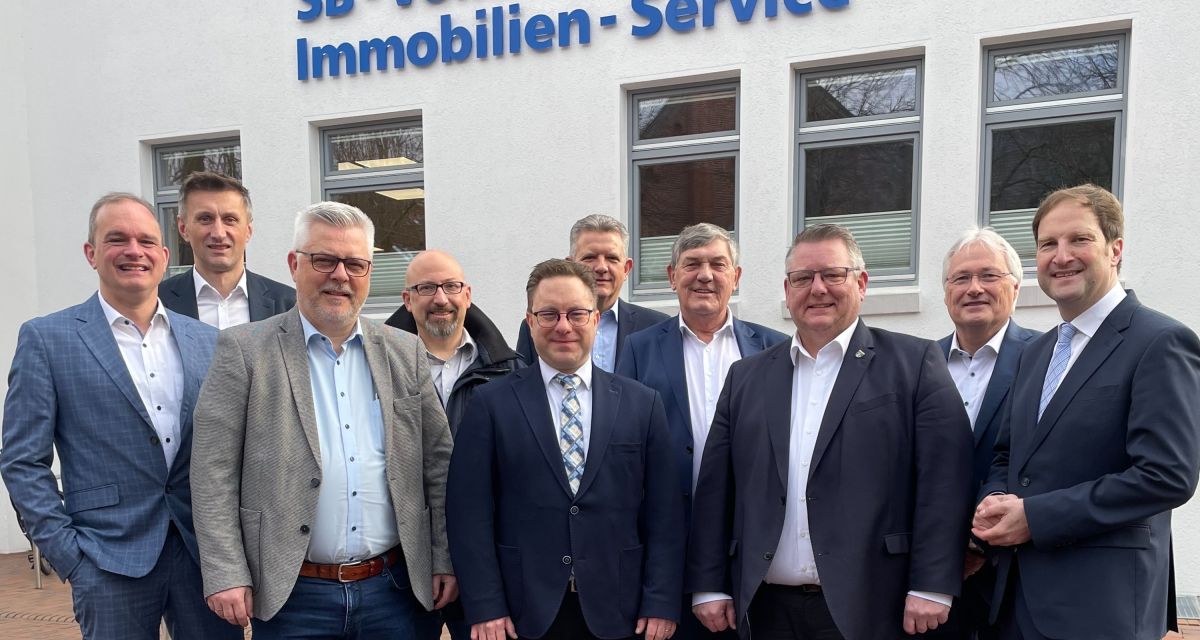 Zusehen sind die Bürgermeister der Kommunen Jever, Sande, Schortens; Wangerland und Wilhelmshaven sowie der Vorstand der volksbank Jever vor dem Bankgebäude.