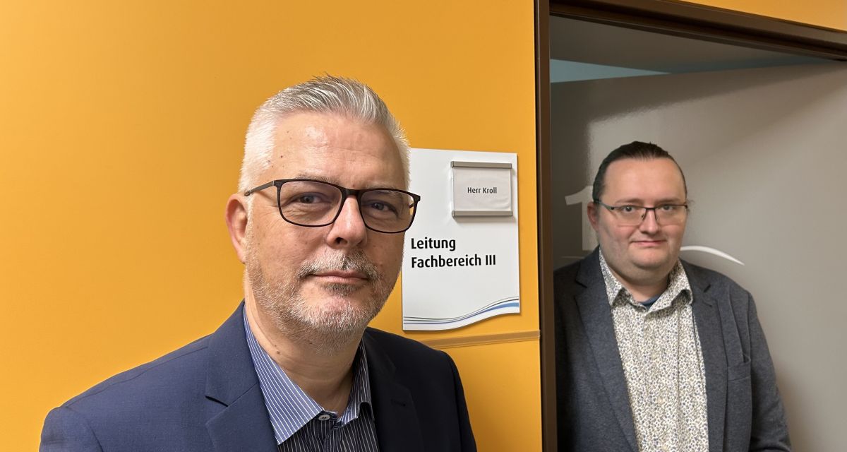 Zu sehen sind in einem Flur des Sander Rathauses Bürgermeister Stephan Eiklenborg und Kämmerer Christian Kroll