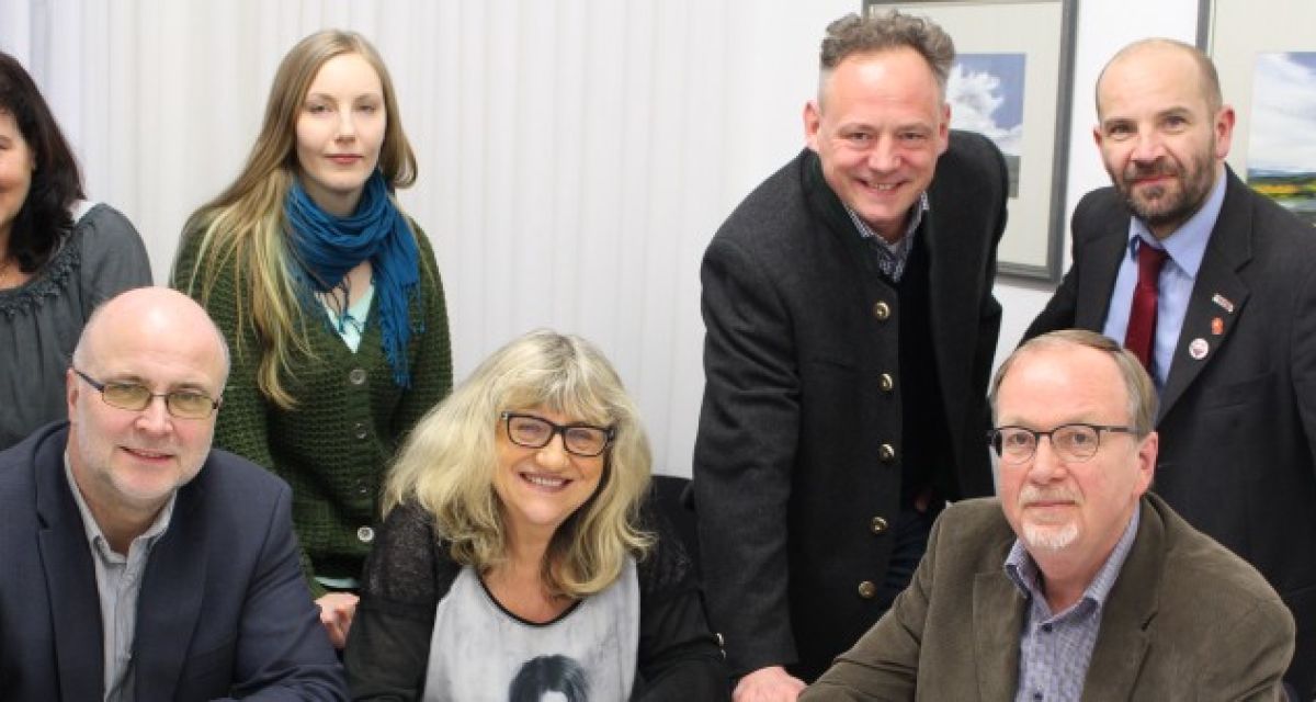 Sieben kommunal-Politiker lächeln in die Kamera.